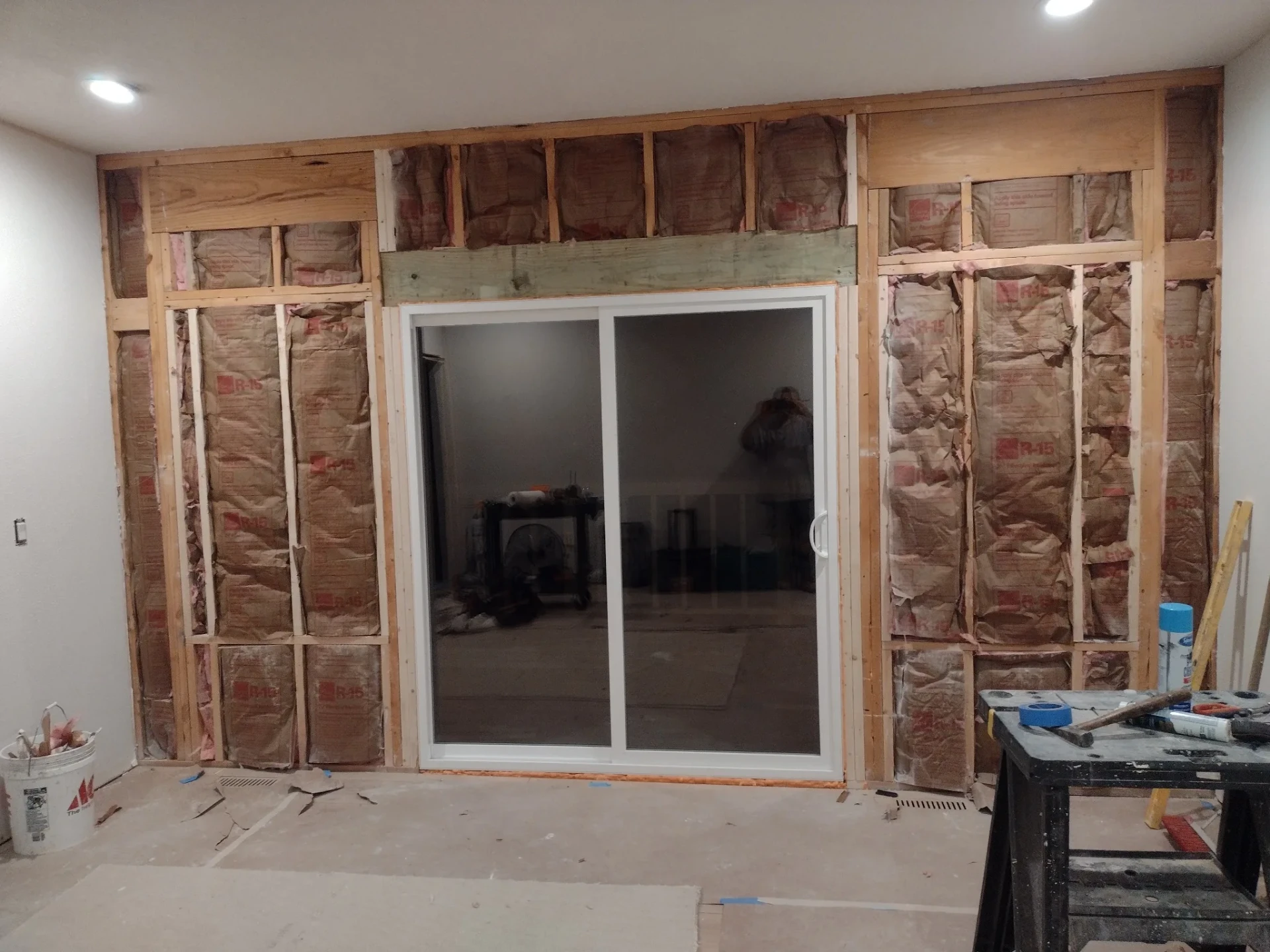 New white sliding patio door set in an open framed and insulated wall